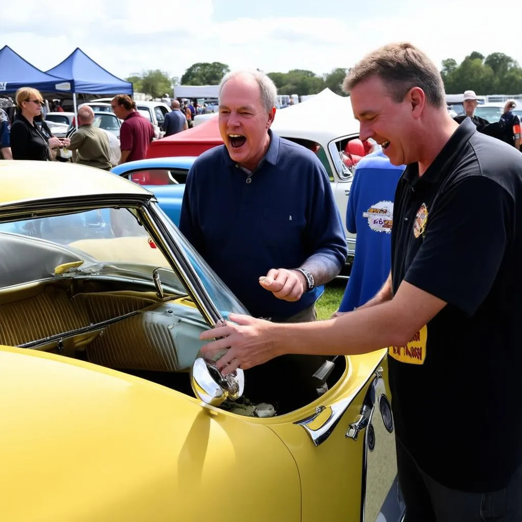 Car enthusiasts chat excitedly at a car show, admiring a classic vehicle.