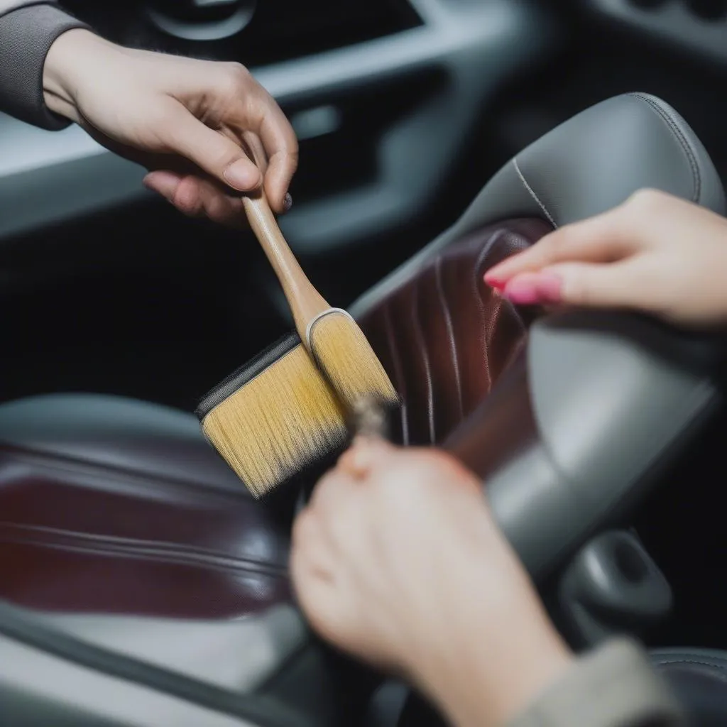 Applying leather dye to car seat