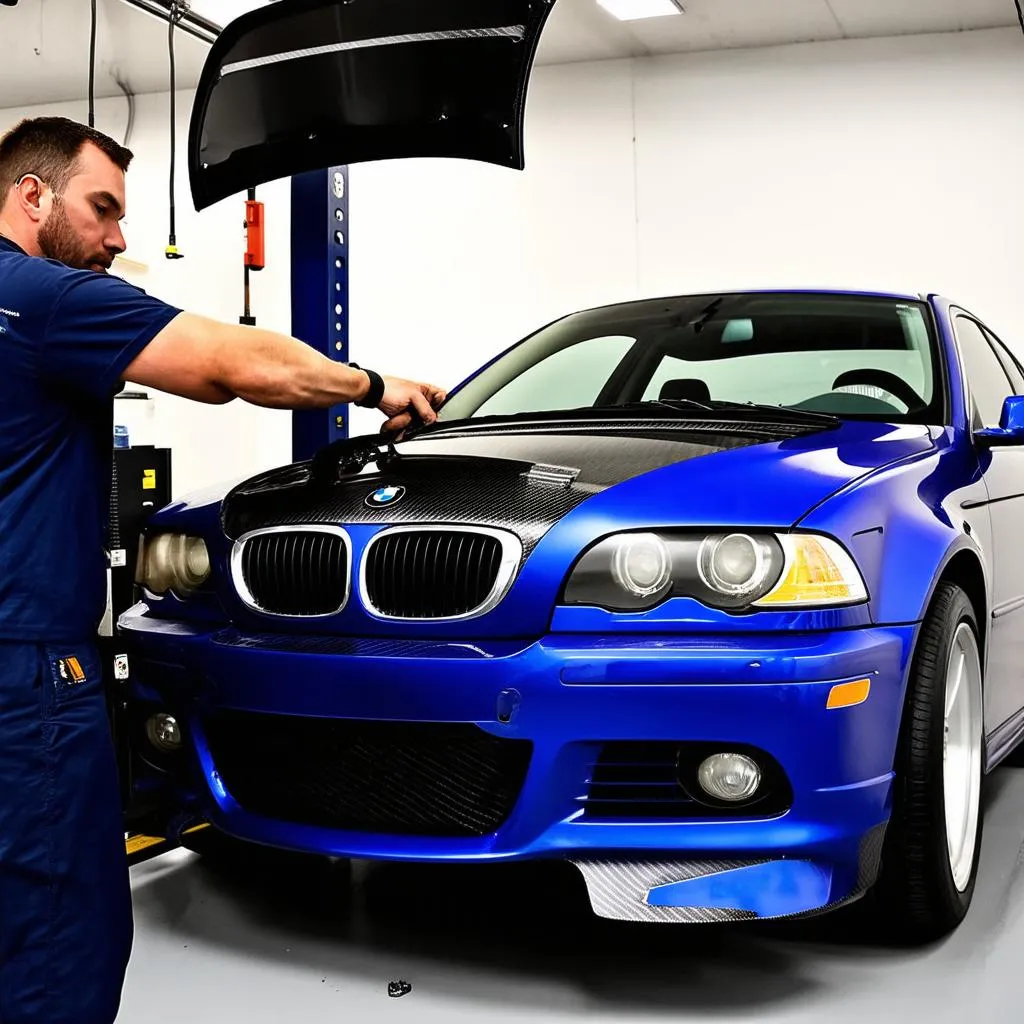 Mechanic installing a carbon fiber hood on a BMW E46