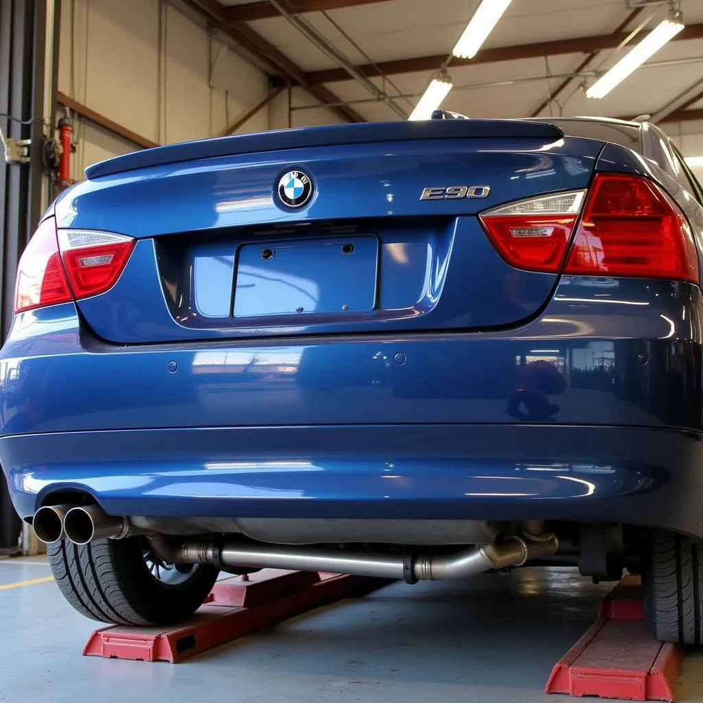 Mechanic Installing an Axle-Back Exhaust on a BMW E90