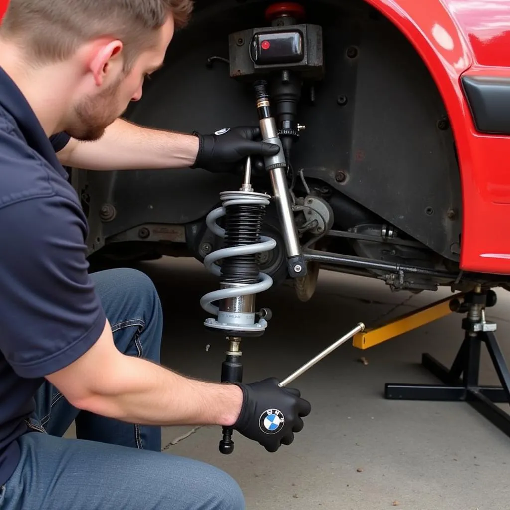 Mechanic adjusting coilovers on a BMW E30