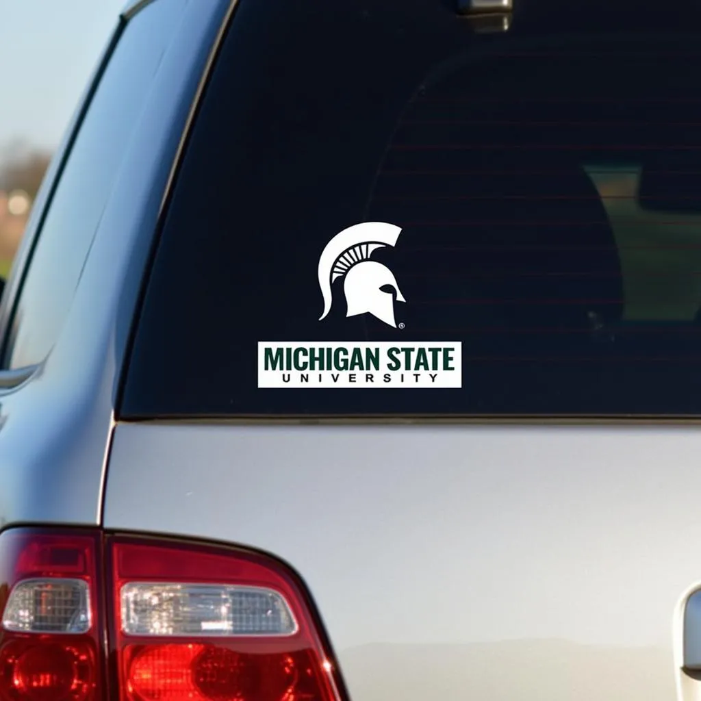 Michigan State car decal displayed on a car window