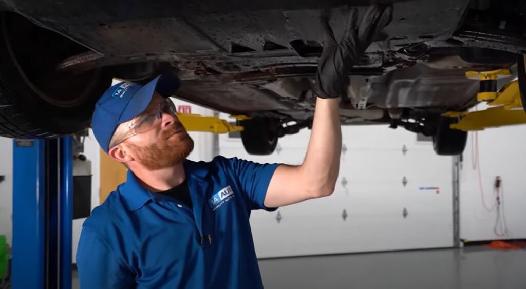 Inspecting the bottom of a car for a dragging splash shield