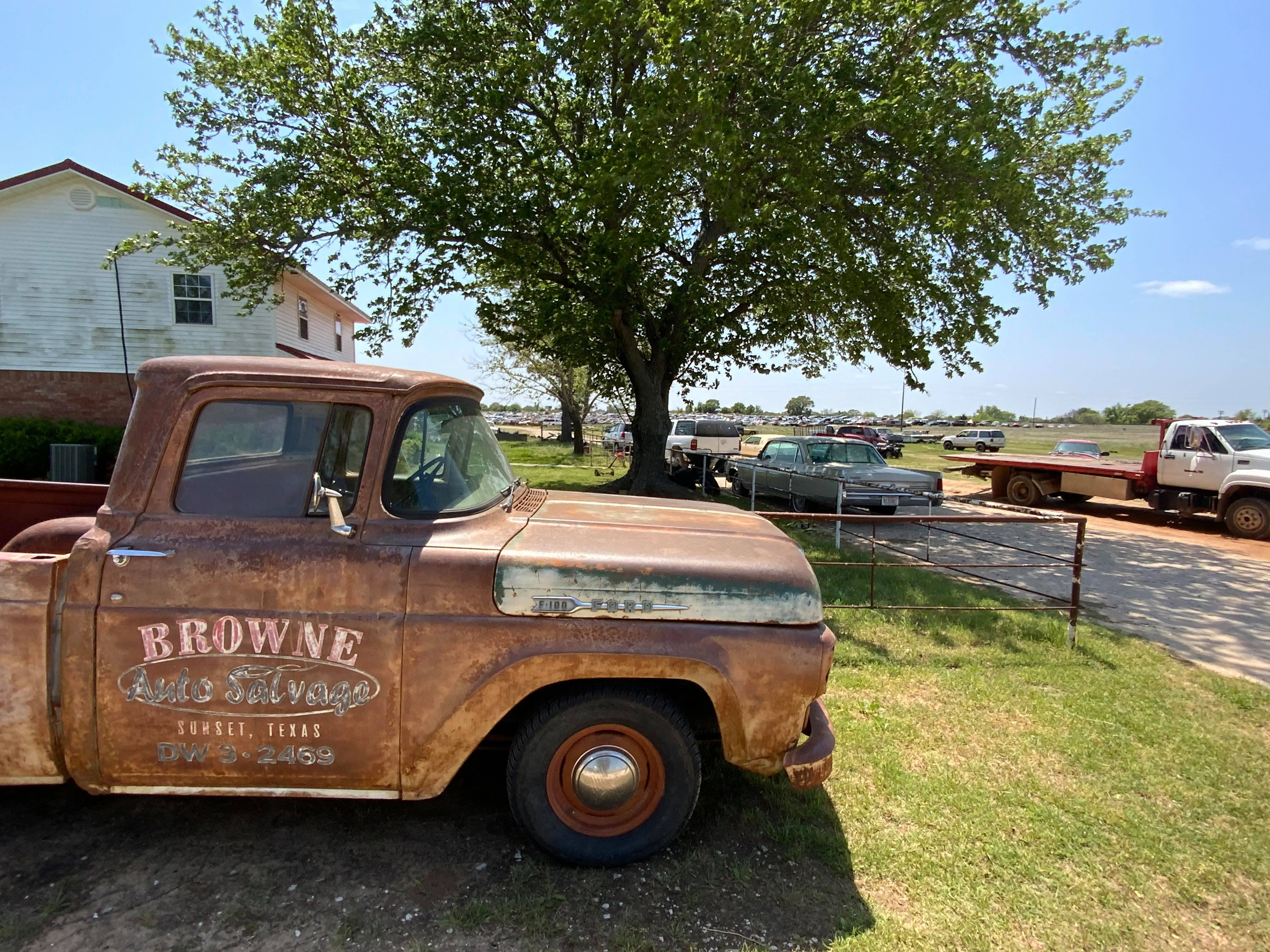 Vintage Ford pickup truck advertising Browne Auto Salvage, indicating arrival at the car parts source in Sunset, Texas.