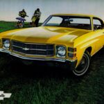 Front view of a red 1971 Chevelle showcasing its single headlights and chrome bumper