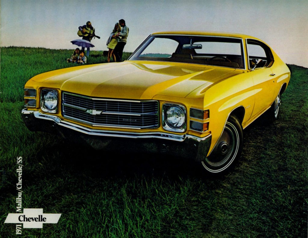 Front view of a red 1971 Chevelle showcasing its single headlights and chrome bumper