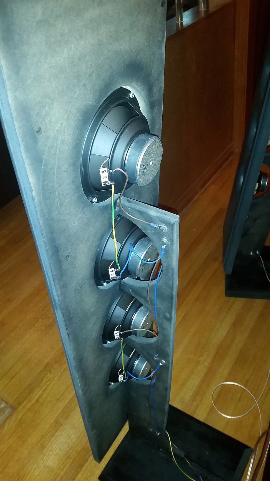 DIY open baffle speaker project showcasing the front baffle with rounded speaker exits.