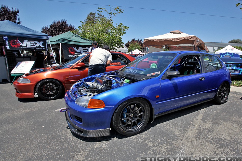 Two tuned Honda Civics from Bandits car crew parked at the Blox Open House 2012, showcasing aftermarket wheels and lowered stance.