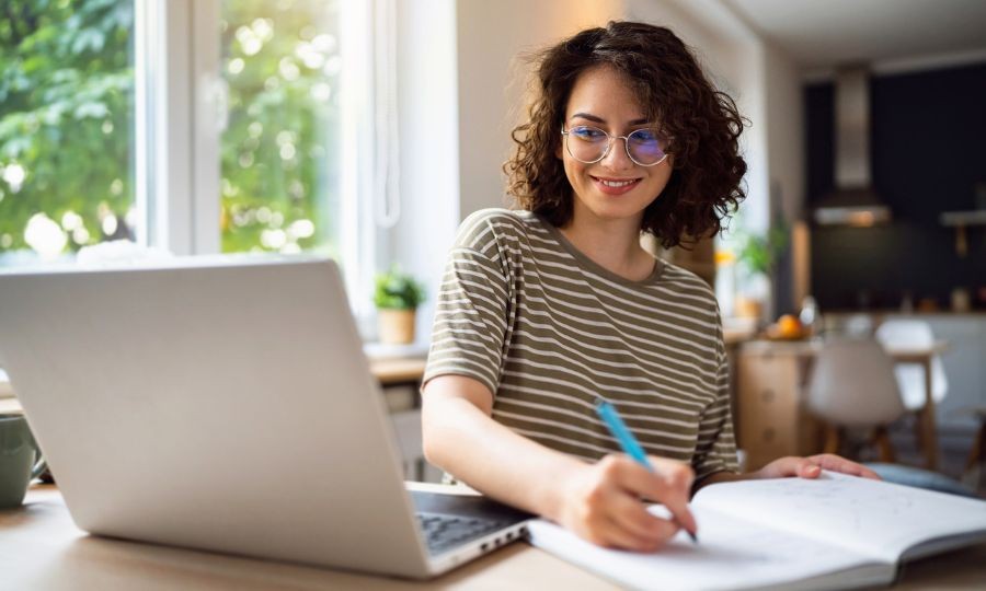 Woman using laptop in a car repair shop