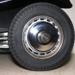 Close-up of a Bugatti model car wheel and tire, showcasing the slim profile and matte finish of the Model Motorcars part, alongside original Pocher parts for comparison.