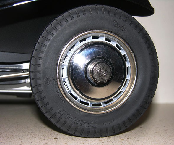 Close-up of a Bugatti model car wheel and tire, showcasing the slim profile and matte finish of the Model Motorcars part, alongside original Pocher parts for comparison.