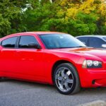 A red Dodge Charger parked in a parking lot.