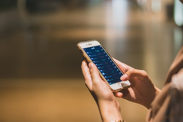 Person checking online car sales on a smartphone. 