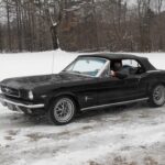 Keith Kelley, classic Mustang owner and 3D printing innovator, standing next to his restored 1964 Ford Mustang convertible, showcasing his passion for vintage cars and modern technology.