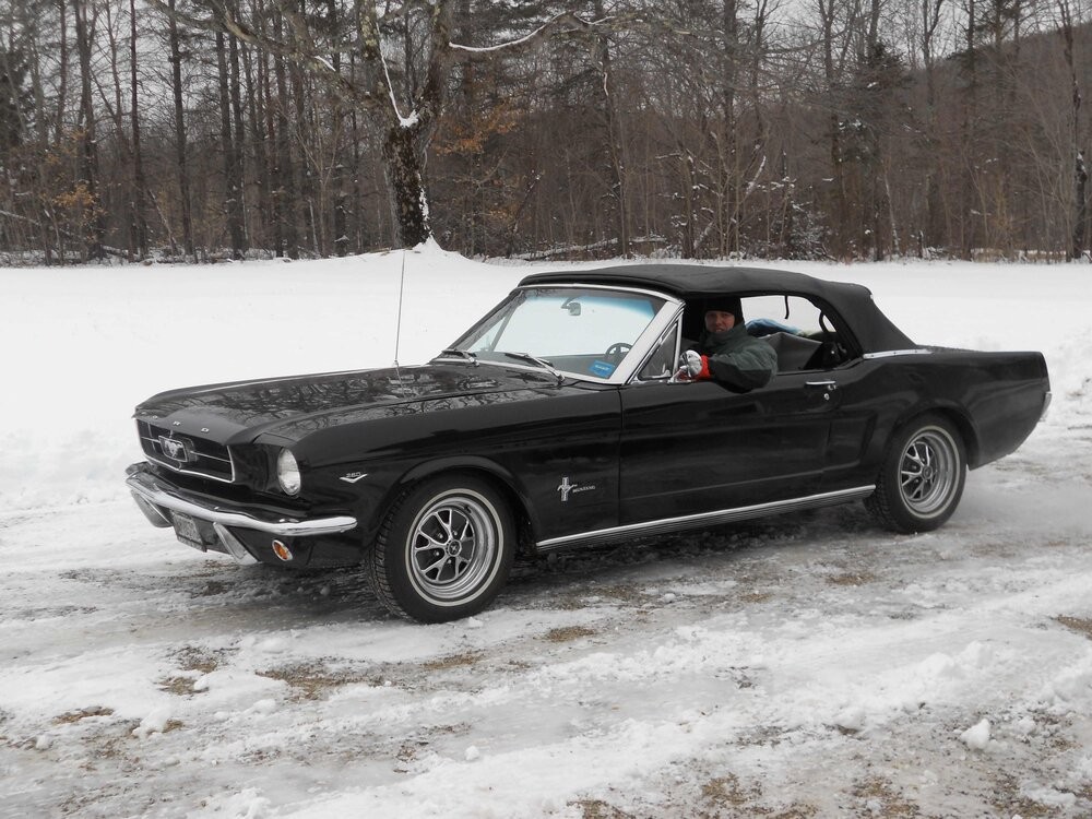 Keith Kelley, classic Mustang owner and 3D printing innovator, standing next to his restored 1964 Ford Mustang convertible, showcasing his passion for vintage cars and modern technology.