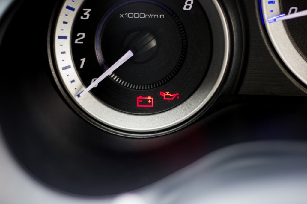 Dashboard of a car with the battery and engine lights on