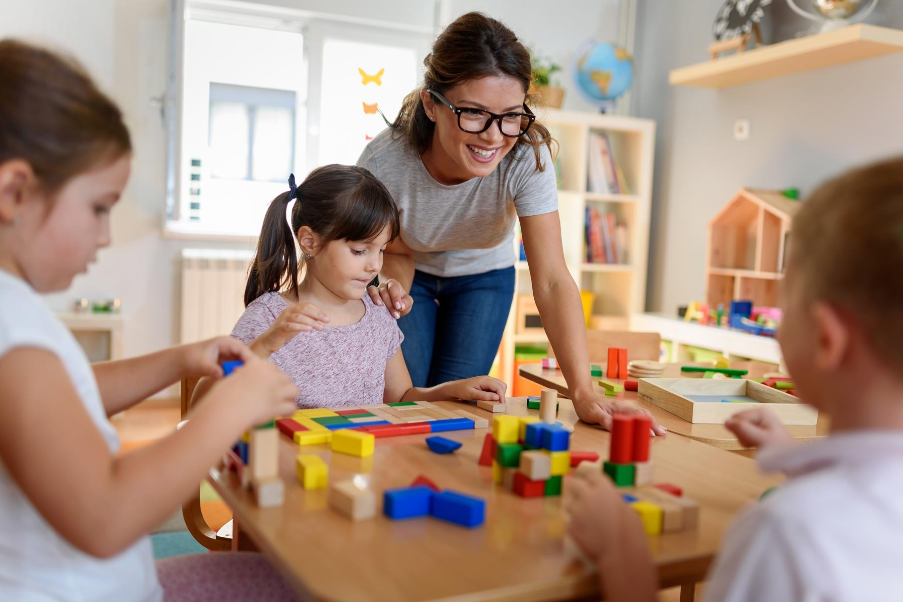 Teacher helping a child at a daycare center